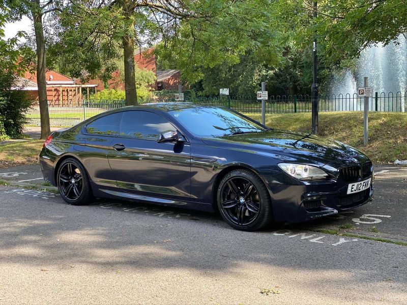 A professional chauffeur-driven BMW 6 Series hire car.