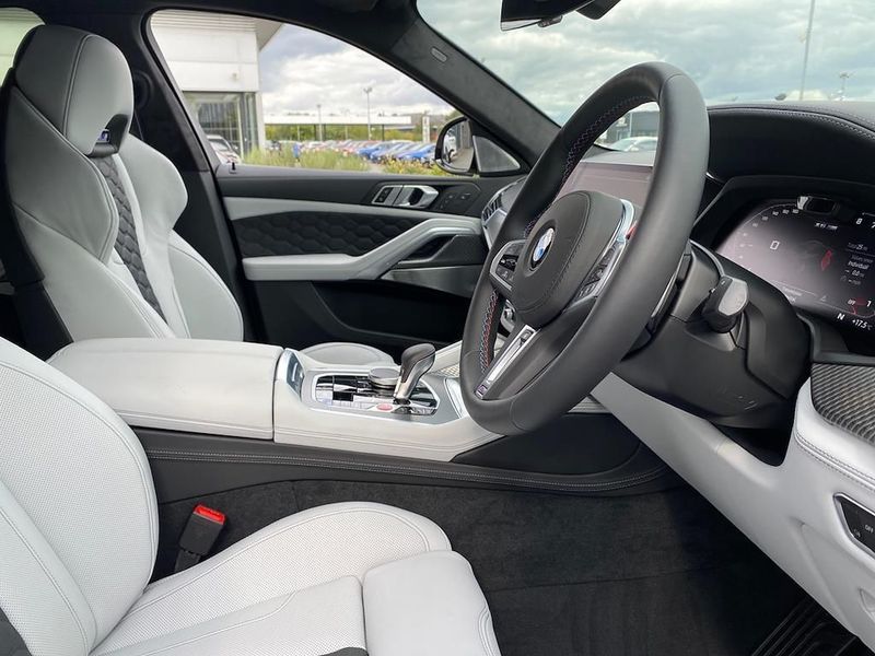 Interior view of the BMW X6M highlighting the luxurious seats and dashboard.