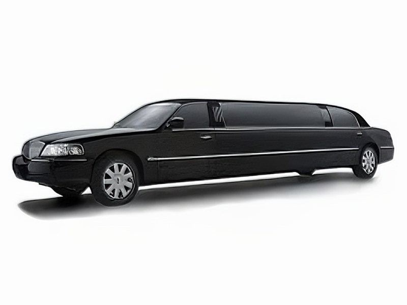 A white chauffeured Lincoln Town Car limousine ready for hire.