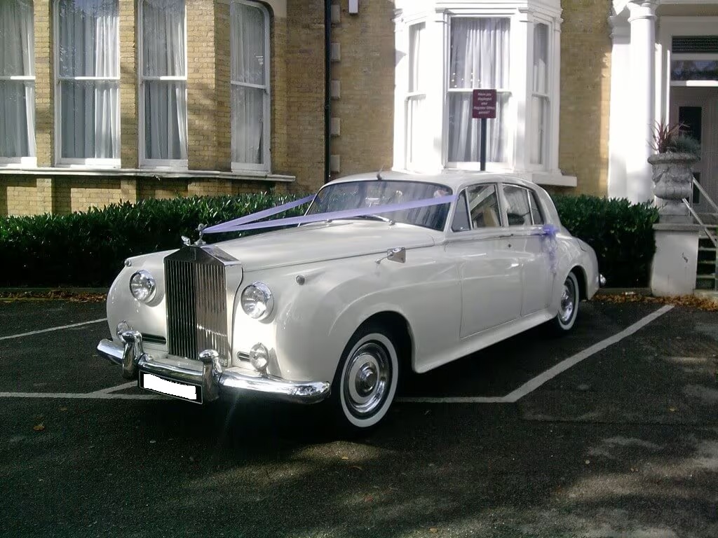 A classic white Rolls Royce Silver Cloud, perfect for a bride's wedding day transport.